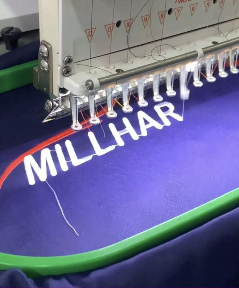 Embroidery machine stitching a logo